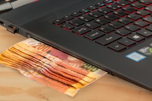 Laptop and money representing passive income